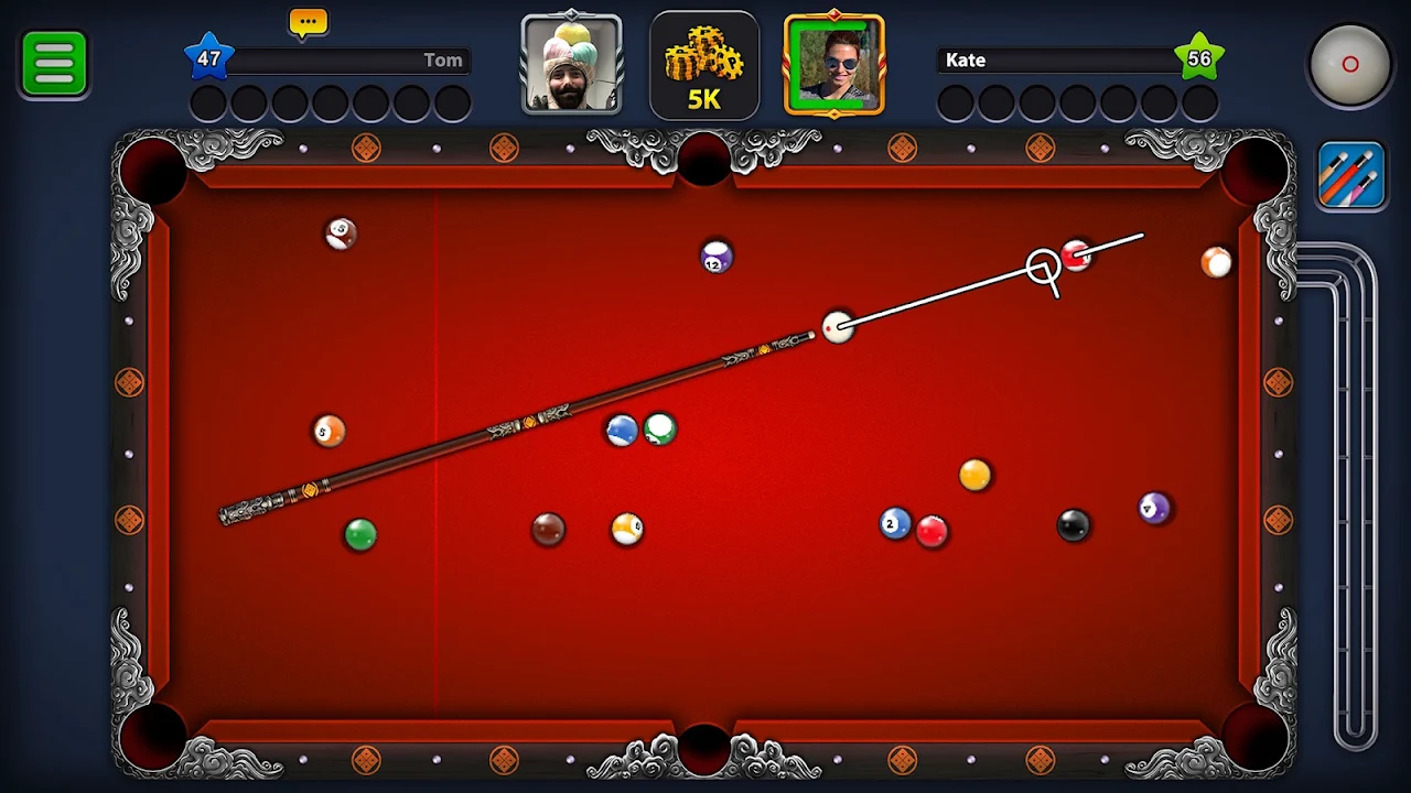 Aiming at a red ball on an ornate red pool table